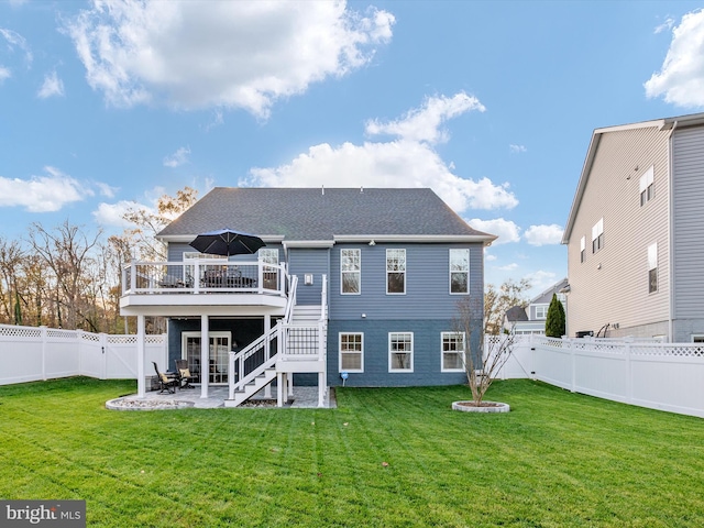 rear view of house with a lawn, a patio area, and a deck