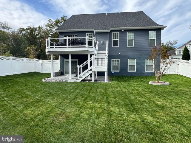 back of property with a lawn, a patio, and a deck