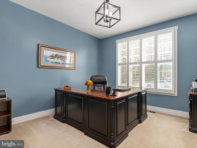 office featuring light colored carpet and a notable chandelier