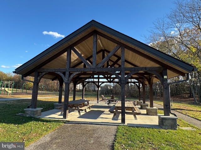 view of community with a playground, a yard, and a gazebo