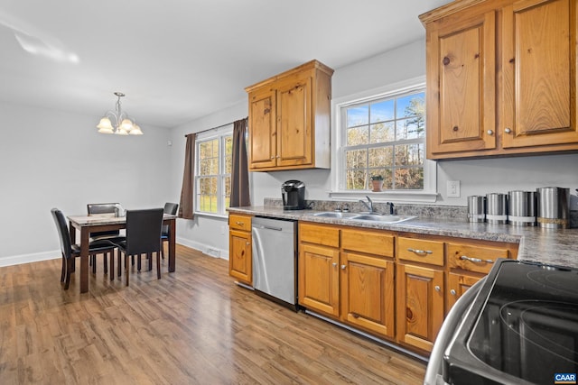 kitchen with a healthy amount of sunlight, light wood-type flooring, range, and stainless steel dishwasher