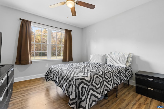 bedroom featuring dark hardwood / wood-style flooring and ceiling fan