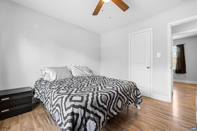 bedroom with hardwood / wood-style flooring and ceiling fan