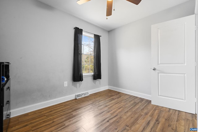 spare room featuring wood-type flooring and ceiling fan