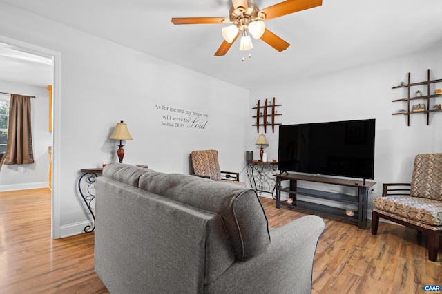 living room with hardwood / wood-style floors and ceiling fan