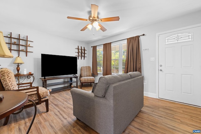 living room featuring wood-type flooring and ceiling fan