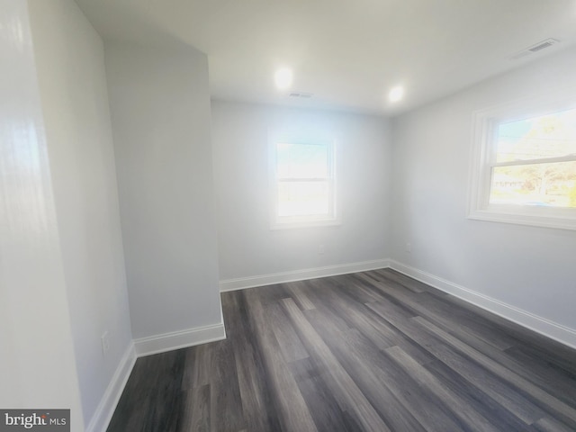 unfurnished room with dark hardwood / wood-style floors