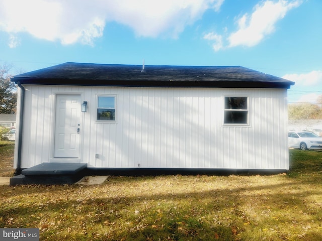 view of side of home with a yard