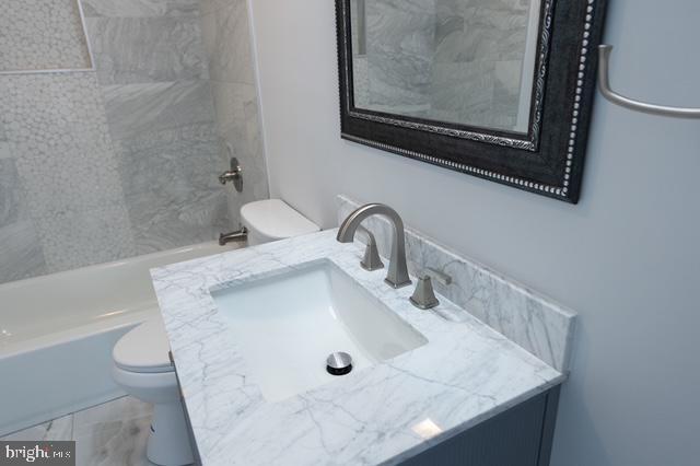 122 Roselawn Rd, Annapolis, MD 21403 - bathroom with vanity, tub / shower combination, and marble finish flooring