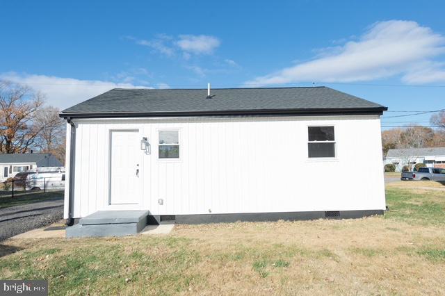 rear view of property with a yard