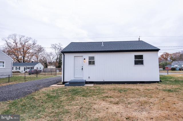 back of property featuring a lawn