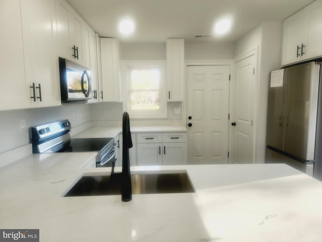 kitchen featuring white cabinetry, sink, and stainless steel appliances