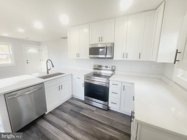 kitchen featuring white cabinetry, sink, and appliances with stainless steel finishes