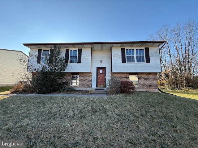 bi-level home with a front lawn