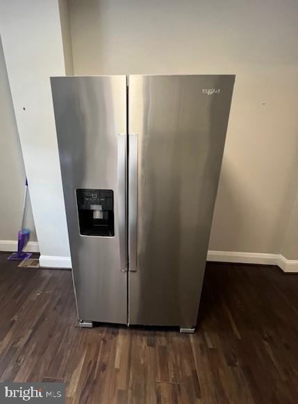 kitchen featuring dark hardwood / wood-style flooring and stainless steel fridge with ice dispenser