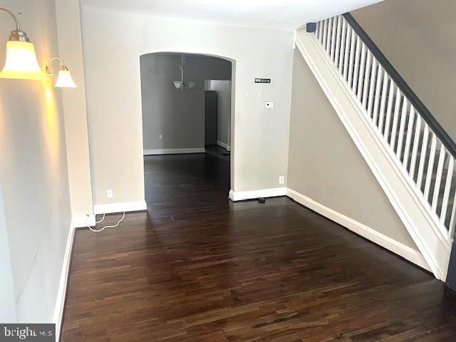 interior space with dark hardwood / wood-style floors and a chandelier