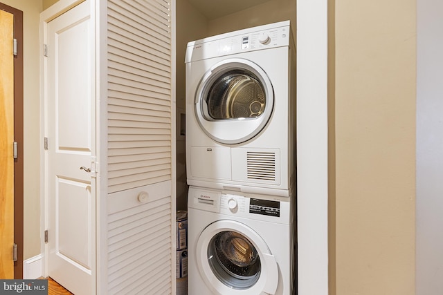 laundry room featuring stacked washer and clothes dryer