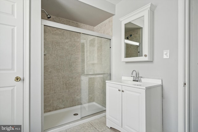 bathroom featuring tile patterned floors, vanity, and a shower with door