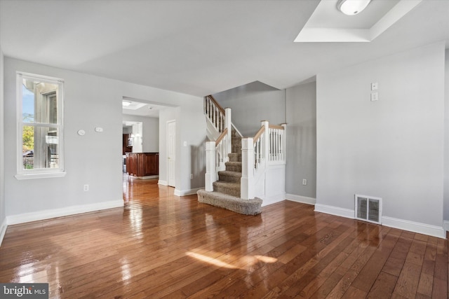 unfurnished living room featuring wood-type flooring