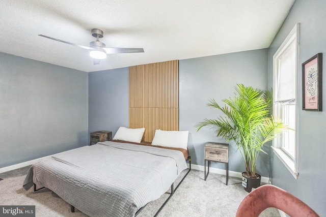 carpeted bedroom featuring a textured ceiling and ceiling fan