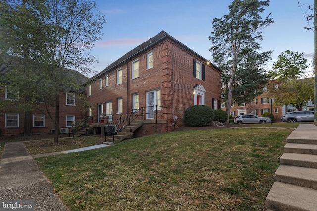 property exterior at dusk with a yard and central air condition unit