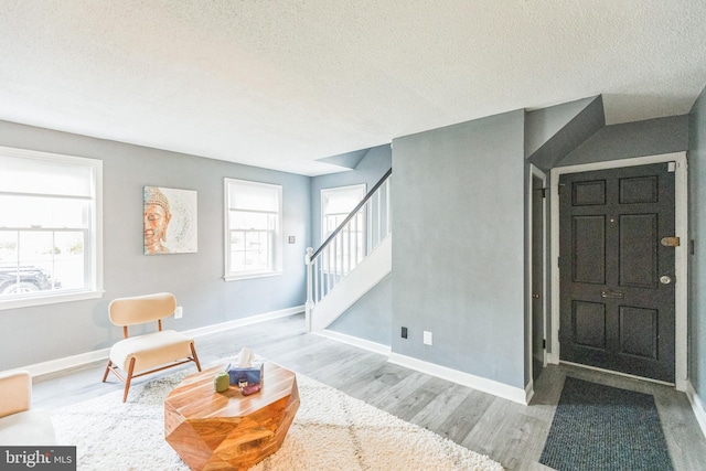 living area with light hardwood / wood-style flooring and a textured ceiling