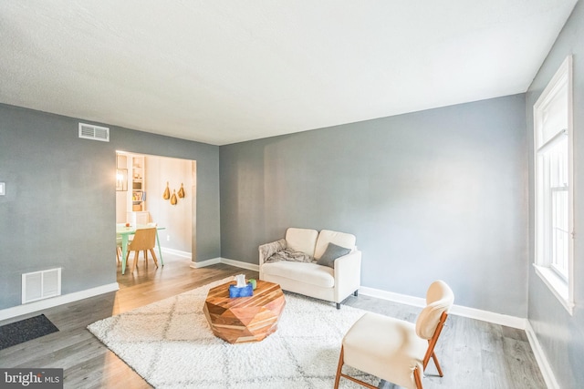 living area with hardwood / wood-style flooring