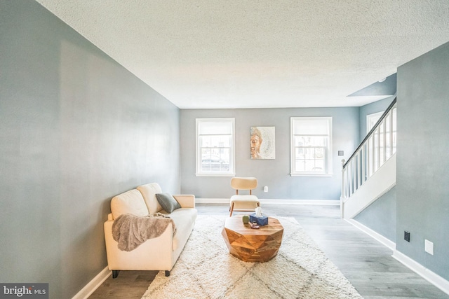 sitting room with a textured ceiling and hardwood / wood-style flooring