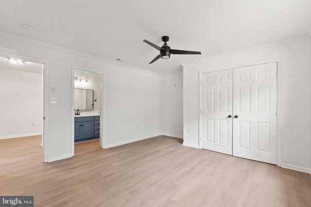 unfurnished bedroom with ensuite bath, ceiling fan, a closet, and light hardwood / wood-style floors