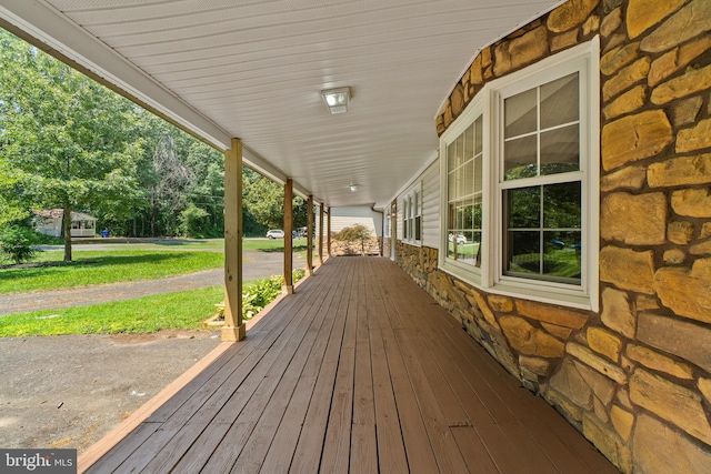 wooden terrace featuring covered porch