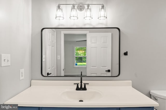 bathroom featuring vanity and toilet