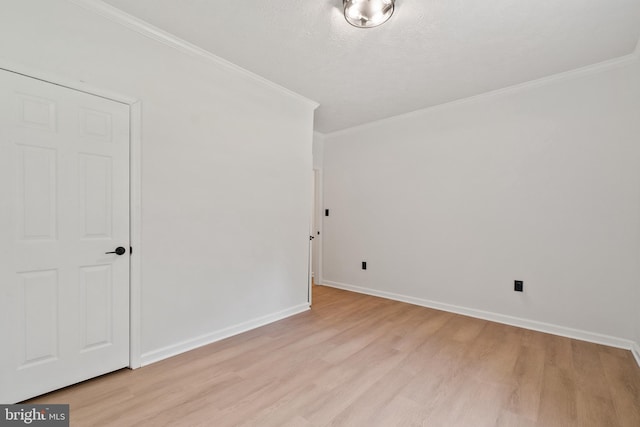 unfurnished room featuring crown molding, light hardwood / wood-style floors, and a textured ceiling