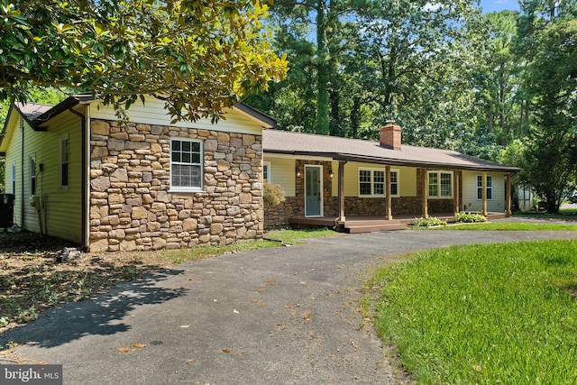 view of front of property featuring central AC unit and a porch