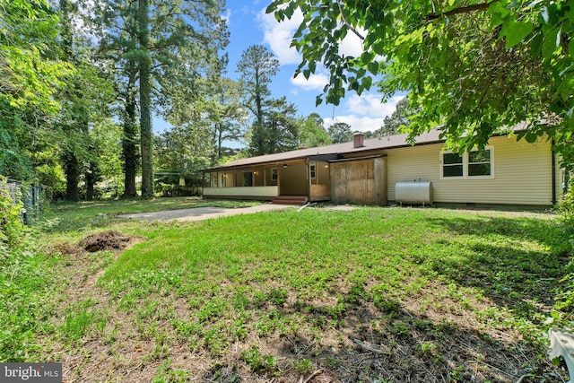 back of property featuring a yard