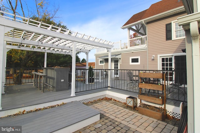 wooden deck featuring a pergola and exterior bar