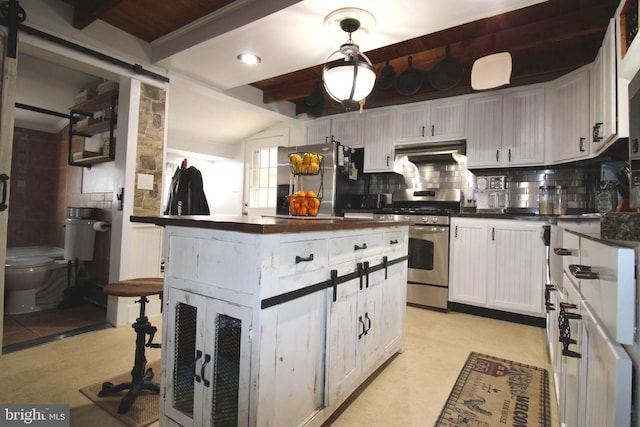 kitchen with tasteful backsplash, lofted ceiling with beams, white cabinetry, and stainless steel appliances