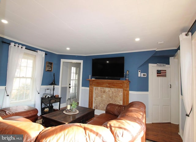 living room featuring crown molding, a high end fireplace, and hardwood / wood-style flooring