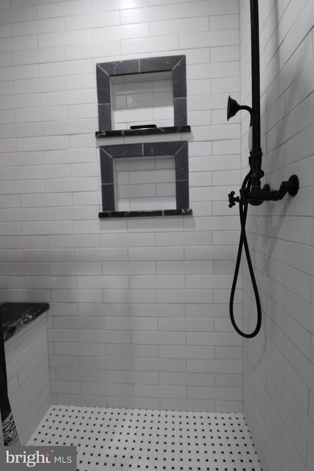 bathroom with a tile shower