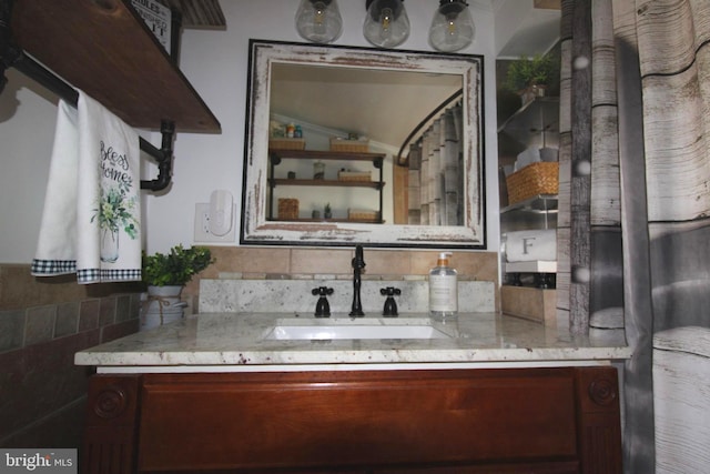 bathroom with tasteful backsplash and vanity