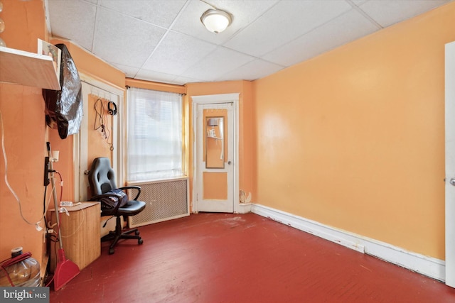 misc room with a paneled ceiling and radiator