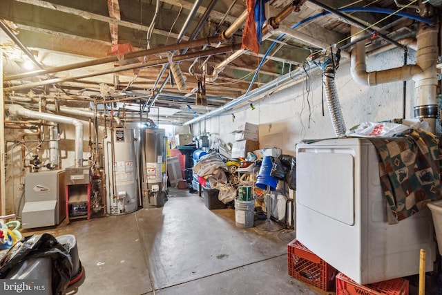 basement with gas water heater and washer / dryer