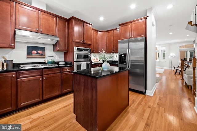 kitchen featuring a kitchen island, light hardwood / wood-style floors, and appliances with stainless steel finishes