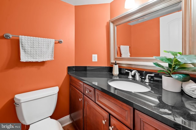 bathroom featuring toilet and vanity