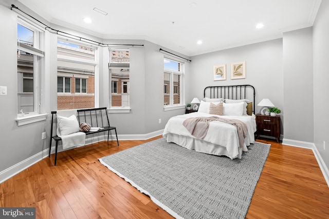 bedroom featuring ornamental molding and hardwood / wood-style flooring