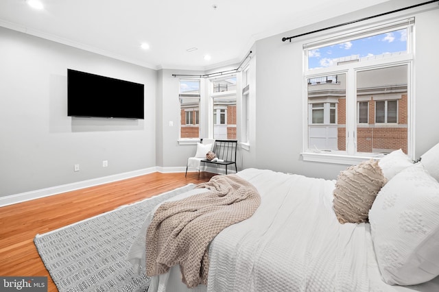 bedroom featuring crown molding and wood-type flooring