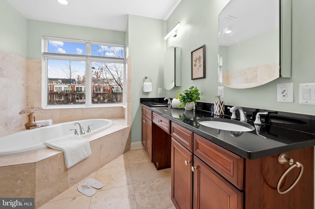 bathroom featuring vanity, tiled bath, and tile patterned floors