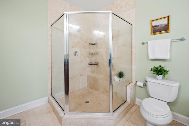 bathroom featuring toilet, tile patterned flooring, and a shower with shower door