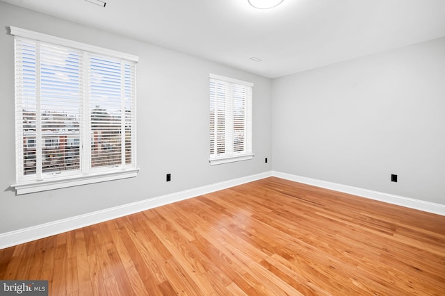 spare room featuring wood-type flooring