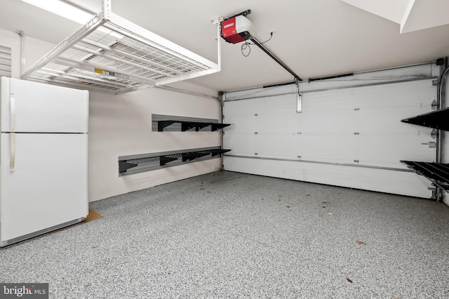 garage with white fridge and a garage door opener