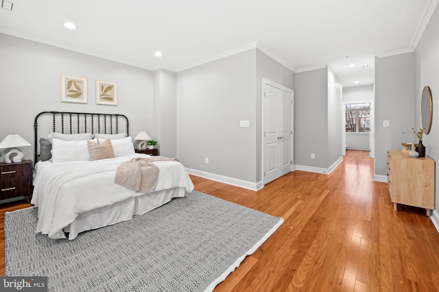 bedroom with light hardwood / wood-style floors and ornamental molding